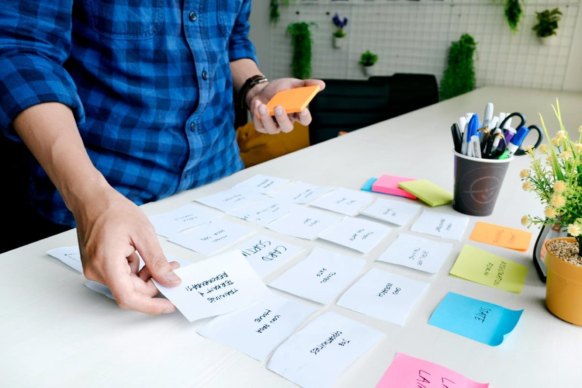 Person making notes on post-it notes